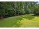 A well manicured back yard, surrounded by mature trees and beautiful plantings at 6175 Weatherly Nw Dr, Sandy Springs, GA 30328