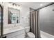 Bathroom featuring a single sink vanity with gray countertop and a bathtub and shower at 6175 Weatherly Nw Dr, Sandy Springs, GA 30328
