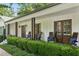 Inviting front porch with wooden chairs and well-maintained landscaping at 6175 Weatherly Nw Dr, Sandy Springs, GA 30328