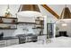Modern kitchen with stainless steel appliances, subway tile backsplash, and open shelving at 6175 Weatherly Nw Dr, Sandy Springs, GA 30328