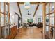 Warm, inviting living room featuring exposed beams, wood floors and lots of natural light at 6175 Weatherly Nw Dr, Sandy Springs, GA 30328