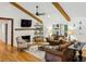 Cozy living room featuring exposed beams, hardwood floors, fireplace, and plenty of seating at 6175 Weatherly Nw Dr, Sandy Springs, GA 30328