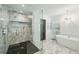 Modern main bathroom with glass shower, freestanding tub, and elegant fixtures at 6175 Weatherly Nw Dr, Sandy Springs, GA 30328