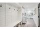 Well-organized mudroom with custom storage, shiplap walls, and laundry facilities at 6175 Weatherly Nw Dr, Sandy Springs, GA 30328