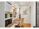 Home office featuring a built-in desk, shelving, and a comfortable chair at 6175 Weatherly Nw Dr, Sandy Springs, GA 30328