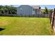 Large, grassy backyard, perfect for outdoor activities and entertaining, surrounded by a wood fence at 15 Regal Ln, Covington, GA 30016