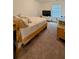 Bright bedroom featuring neutral carpet, a bed, and a large window at 15 Regal Ln, Covington, GA 30016