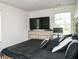 Bright bedroom featuring neutral walls, natural light, and black bedding at 15 Regal Ln, Covington, GA 30016