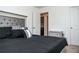 Bright bedroom featuring neutral walls, black bedding, and an open closet at 15 Regal Ln, Covington, GA 30016