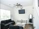 Cozy bonus room with a ceiling fan and ample natural light streaming through the windows at 15 Regal Ln, Covington, GA 30016