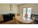 Cozy dining area featuring a wooden table, chairs, and modern appliances at 15 Regal Ln, Covington, GA 30016