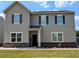 Charming two-story home with neutral siding, dark shutters, and a welcoming front porch at 15 Regal Ln, Covington, GA 30016