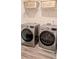 Modern laundry room with front-load washer and dryer and hard surface flooring at 15 Regal Ln, Covington, GA 30016