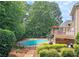 Multi-level backyard with a deck and swimming pool at 215 Settindown Ct, Roswell, GA 30075