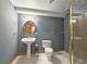 Bathroom features a pedestal sink, modern toilet, and a glass-enclosed shower at 215 Settindown Ct, Roswell, GA 30075