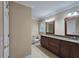 Spacious bathroom features dual sink granite vanity, tile floors, and two mirrors at 215 Settindown Ct, Roswell, GA 30075