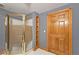 Bathroom featuring a tiled shower, built-in shelving and a wooden door at 215 Settindown Ct, Roswell, GA 30075