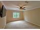 Bedroom features carpeted floors, ceiling fan and window at 215 Settindown Ct, Roswell, GA 30075