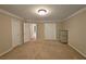 Bedroom features carpeted floors, two closets and adjoining room at 215 Settindown Ct, Roswell, GA 30075