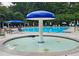 Resort-style community pool with mushroom water feature and ample seating at 215 Settindown Ct, Roswell, GA 30075