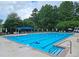 Large community pool with multiple lap lanes, sunshades, and plenty of lounge chairs, perfect for summer fun at 215 Settindown Ct, Roswell, GA 30075