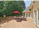 Outdoor deck with seating, a red umbrella, and access to the house at 215 Settindown Ct, Roswell, GA 30075