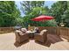 Relaxing deck area features comfortable wicker seating, umbrella, and a gas grill for outdoor gatherings at 215 Settindown Ct, Roswell, GA 30075