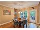 Cozy dining area with round table and sliding door access to back patio, perfect for outdoor dining at 215 Settindown Ct, Roswell, GA 30075