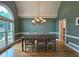 Formal dining room with ample seating and natural light, chandelier, and trim detail at 215 Settindown Ct, Roswell, GA 30075