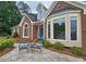 Welcoming front facade with a cozy seating area and blue front door at 215 Settindown Ct, Roswell, GA 30075
