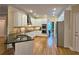 Bright kitchen with white cabinets, stainless steel appliances, granite countertops and island with a sink at 215 Settindown Ct, Roswell, GA 30075