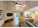 Inviting living room with TV, hardwood floors, access to the kitchen, and two-story vaulted ceilings at 215 Settindown Ct, Roswell, GA 30075
