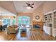 Bright and airy living room with vaulted ceilings, fireplace, built-in shelving, and access to outdoor patio at 215 Settindown Ct, Roswell, GA 30075