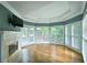 Bright living room featuring hardwood floors, fireplace, and a wall of windows with a trey ceiling at 215 Settindown Ct, Roswell, GA 30075