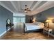 Spacious main bedroom with a tray ceiling and large windows at 215 Settindown Ct, Roswell, GA 30075