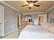 Spacious carpeted main bedroom with ceiling fan, and ensuite bathroom at 215 Settindown Ct, Roswell, GA 30075