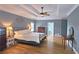 Large main bedroom boasting a tray ceiling, hardwood floors, and plenty of space at 215 Settindown Ct, Roswell, GA 30075