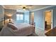 Comfortable main bedroom with carpet, ceiling fan, crown moulding, and ensuite half bath at 215 Settindown Ct, Roswell, GA 30075