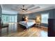 Spacious main bedroom with a tray ceiling and a sitting area at 215 Settindown Ct, Roswell, GA 30075