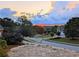 Picturesque neighborhood view with a stunning sunset in the background at 215 Settindown Ct, Roswell, GA 30075