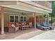 Covered patio with an outdoor seating area with sun-loungers next to the pool, creating a private and inviting retreat at 215 Settindown Ct, Roswell, GA 30075