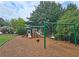 Community playground with swings, slide, and play structure at 215 Settindown Ct, Roswell, GA 30075