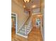 Open staircase leading to a loft with views of the entryway below at 215 Settindown Ct, Roswell, GA 30075