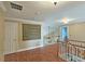 Second floor landing with hardwood floors, neutral paint, and railing overlooking front door at 215 Settindown Ct, Roswell, GA 30075