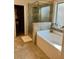 Bathroom features a bathtub and glass door shower at 2208 Ginger Lake Ne Dr, Conyers, GA 30013