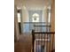 Second-floor hallway with a large window and a view of the staircase at 2208 Ginger Lake Ne Dr, Conyers, GA 30013