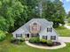 Charming two-story home featuring gray siding, brick accents, a landscaped yard, and mature trees at 504 Bradford Park Ct, Loganville, GA 30052