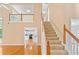 Inviting foyer features hardwood floors, staircase, and a view into the adjacent eat-in kitchen at 504 Bradford Park Ct, Loganville, GA 30052
