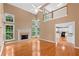 Spacious living room with fireplace, hardwood floors and view of the Kitchen at 504 Bradford Park Ct, Loganville, GA 30052