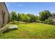 Spacious backyard with healthy green grass, shade trees, and exterior lounge furniture at 538 Main St, Palmetto, GA 30268